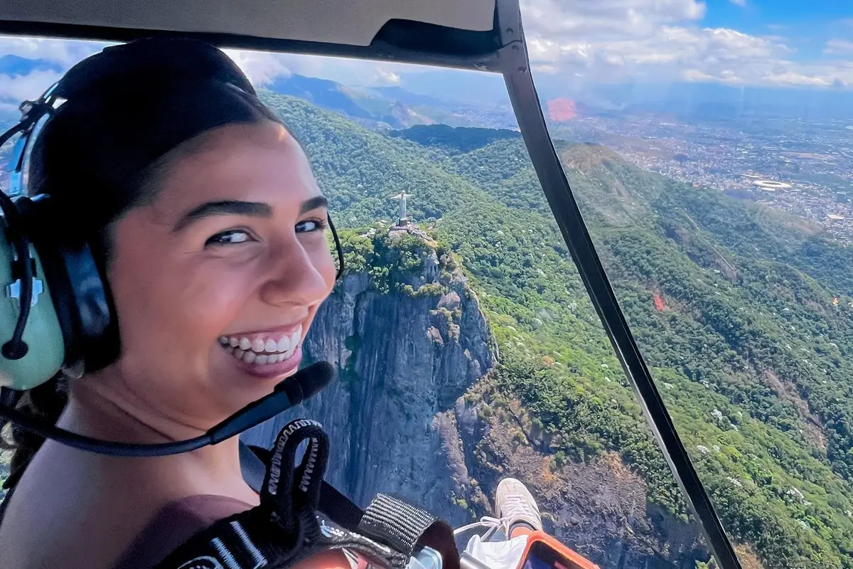 Christ the Redeemer statue seen from above with Rio's skyline behind on a helicopter ride over Rio de Janeiro